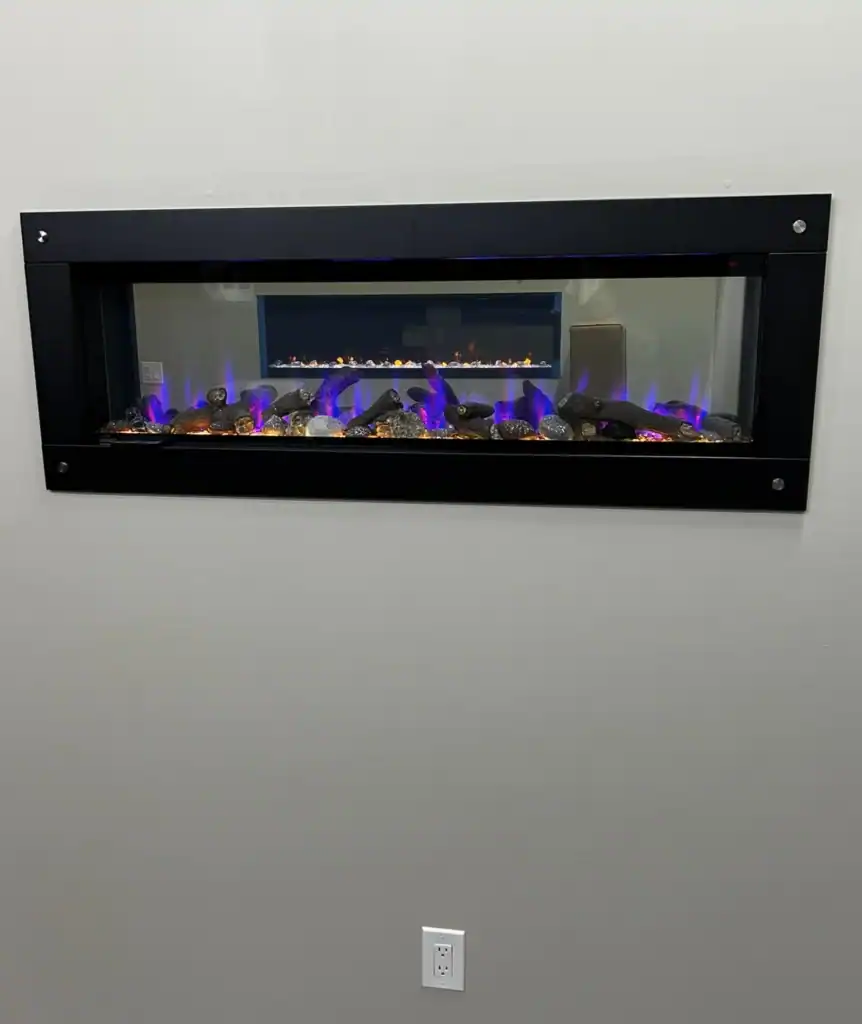 see-through electric fireplace in a wall with another fireplace behind it
